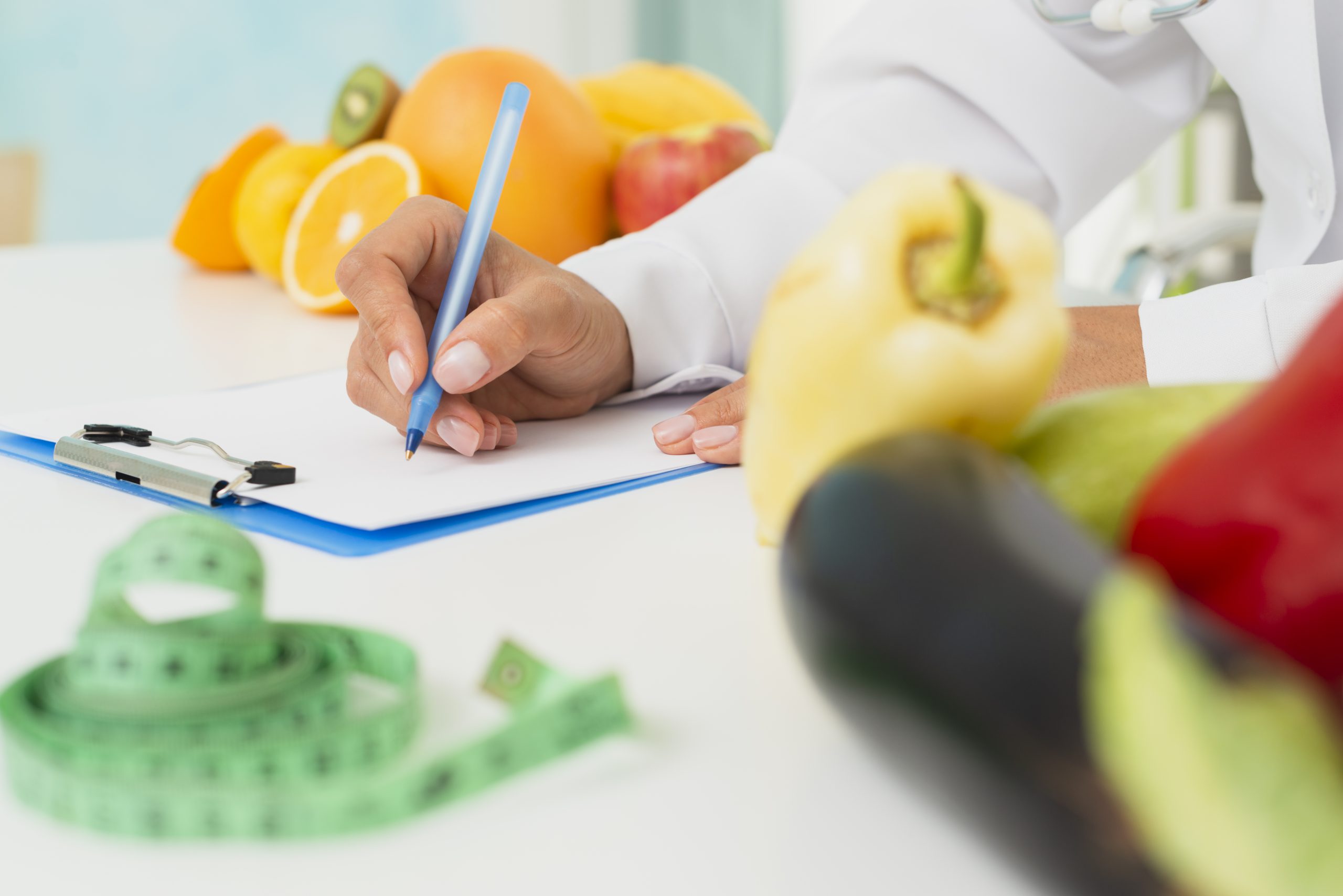 close-up-nutritionist-writing-prescription